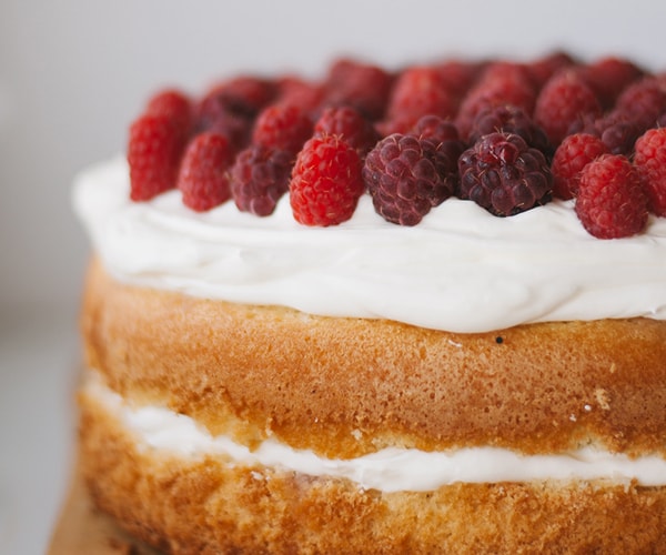 Fluffy sponge cake with cream and raspberries