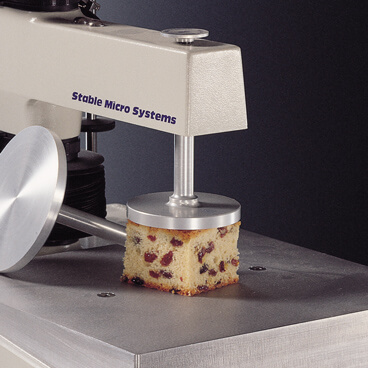 Compression platen testing cake sample