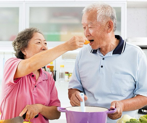 Elderly couple sharing food
