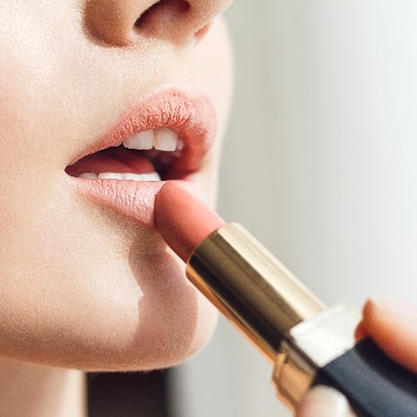 Applying lipstick
