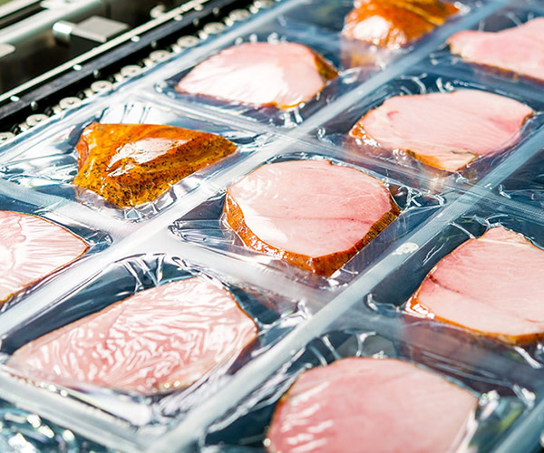 Plastic packaging of meat products