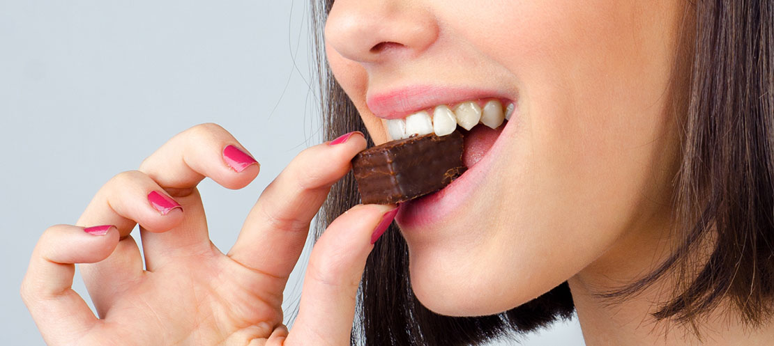 Girl biting into chocolate